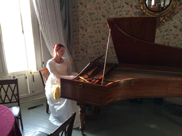 At the piano. . .
